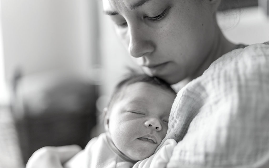 Mother cradles her baby that has a birth injury.