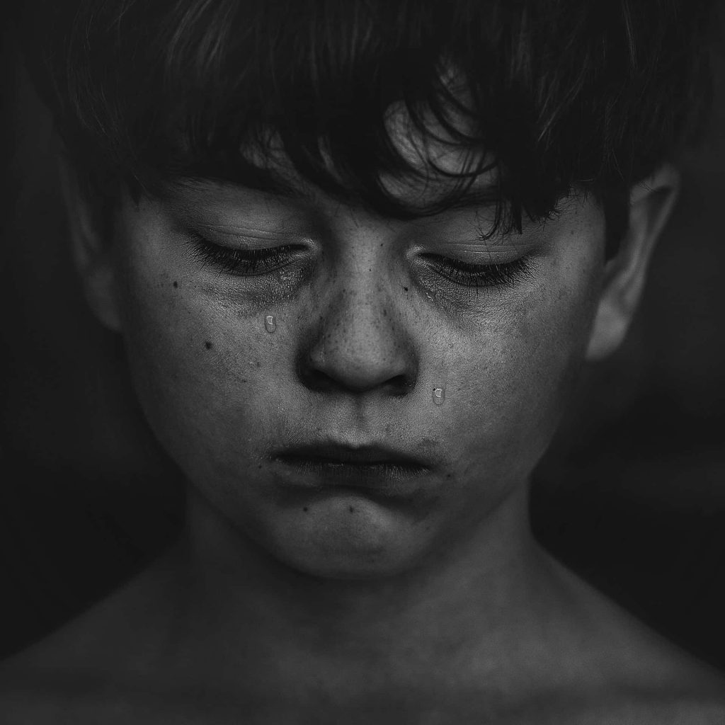 Young boy with tears streaming down his face
