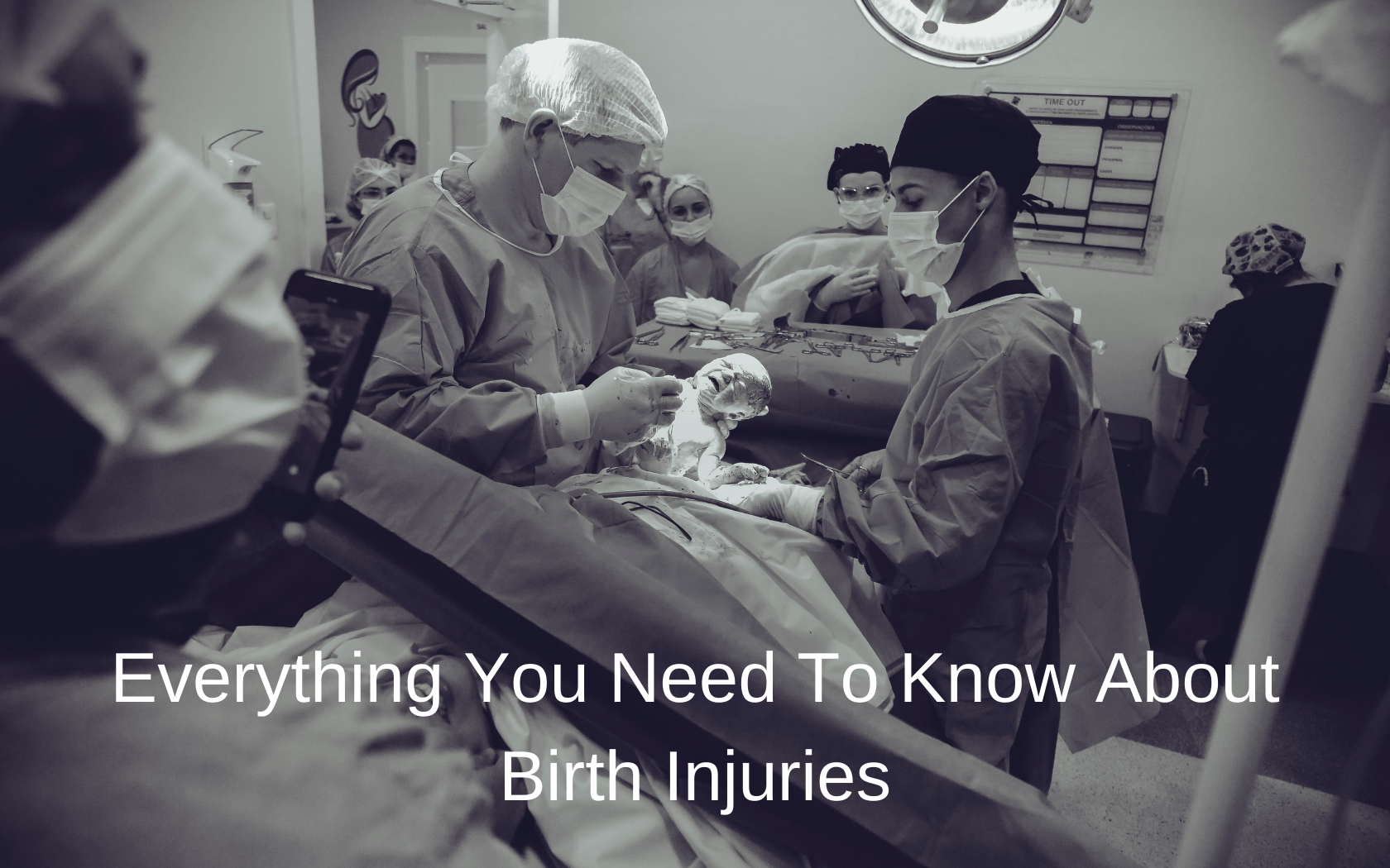 A delivery room full of nurses and doctors.