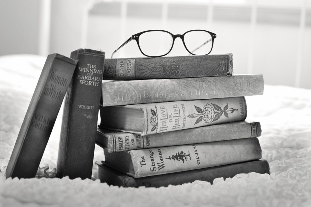Stack of books with glasses on top