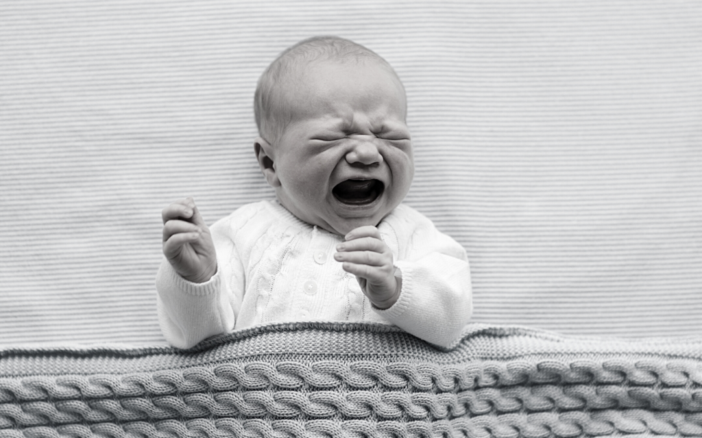 Baby with birth defect crying.