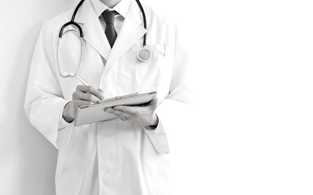 Doctor writing on a clipboard to diagnose a patient. 