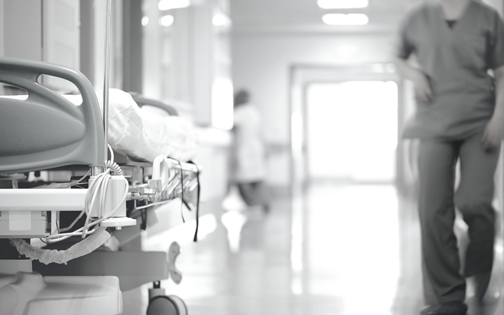 Nurse walks through empty hospital.