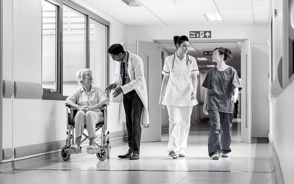 Doctors and nurses walking down a hospital hall.