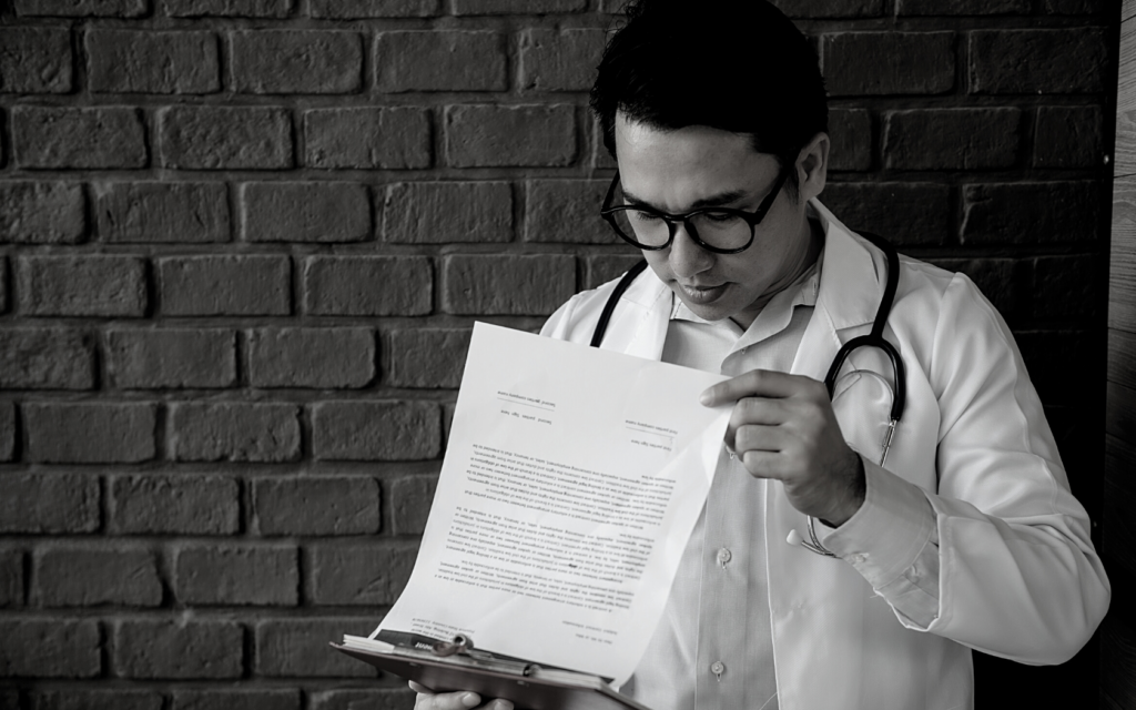 Doctor looks through medical records.