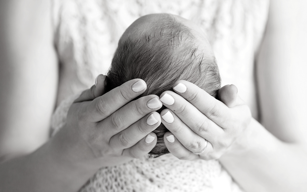 Mother holding her newborn baby.