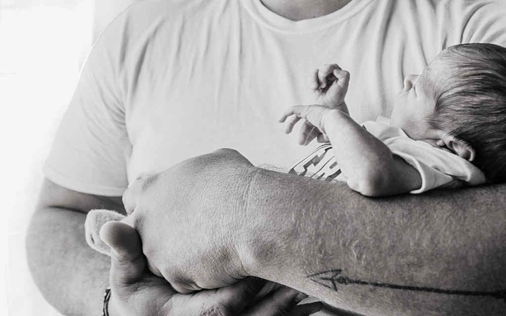 Father holds his newborn baby.