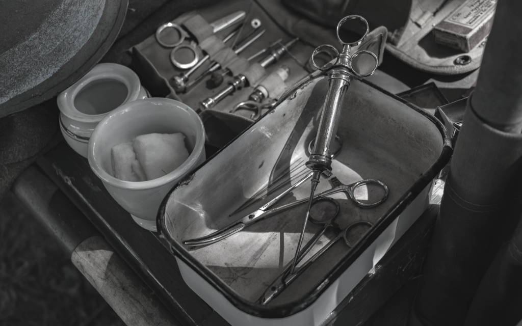 A tray full of vintage surgical equipment. 