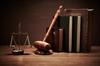 Gavel, law books and scales of justice sitting on a desk