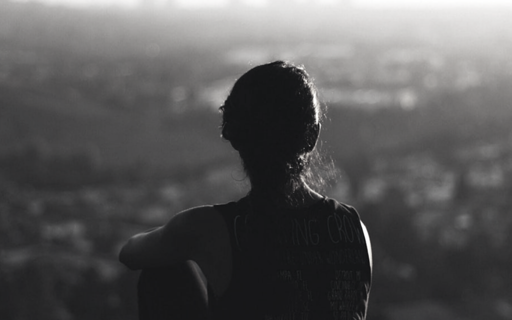 Woman gazing over the landscape, deep in thought.