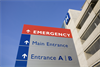 Emergency sign showing directions to the main entrance of hospital.