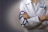Doctor with arms crossed holding a stethoscope