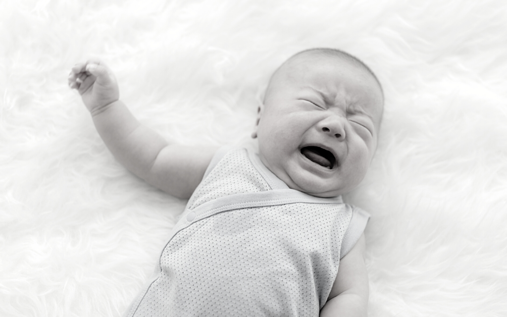 Baby boy cries in pain.