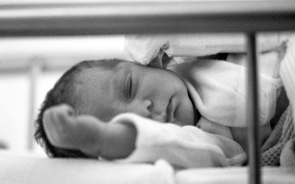 Baby in neonatal care center sleeps.