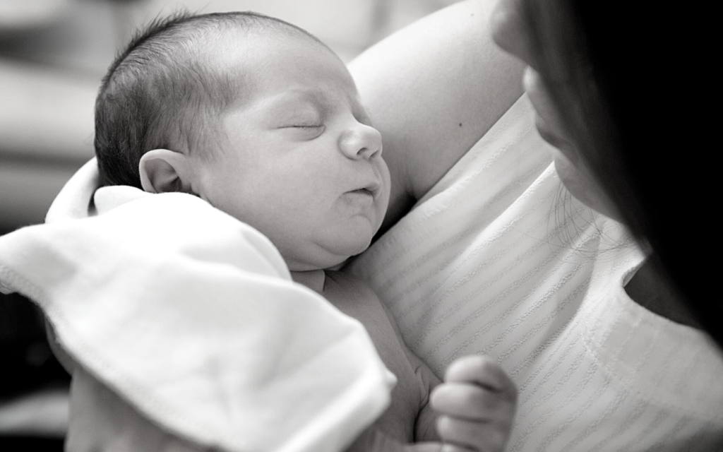 Mother holds her newborn baby.