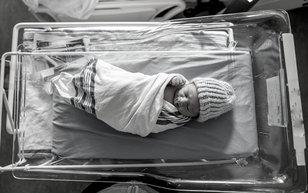 Swaddled infant in hospital. 