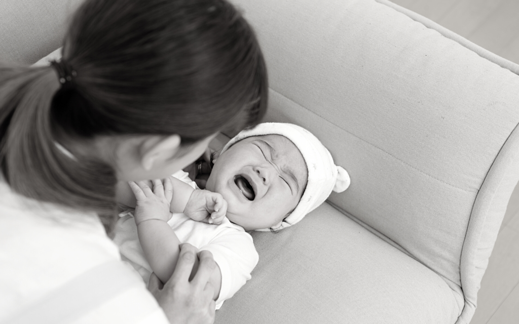 Baby with shoulder dystocia complications cries in pain.
