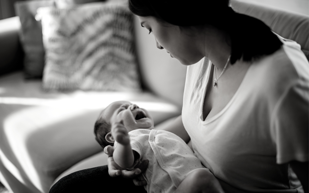 Mother holds baby with brachial plexus injury.