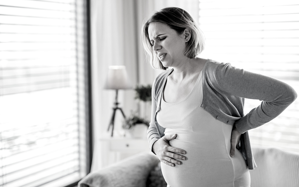 Pregnant woman experiencing pain. 