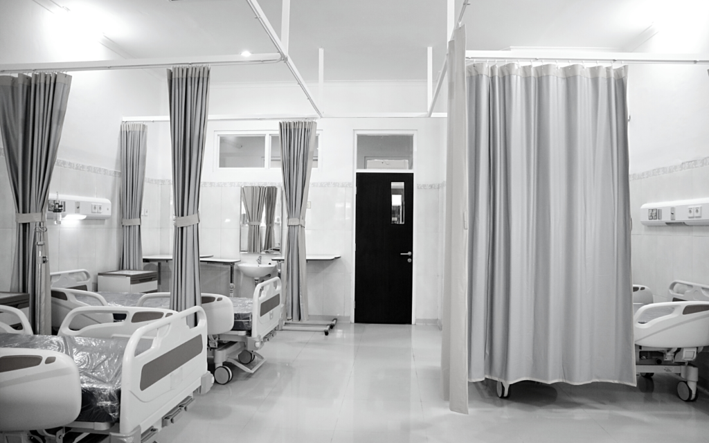 Room full of empty hospital beds.