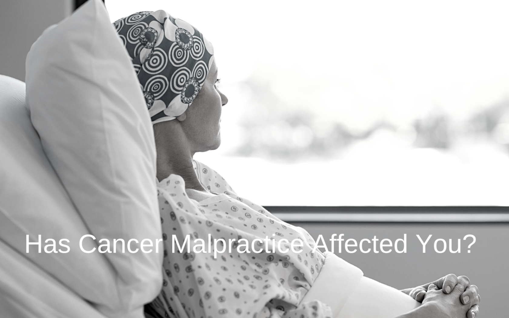 Cancer malpractice victim lies in hospital bed.