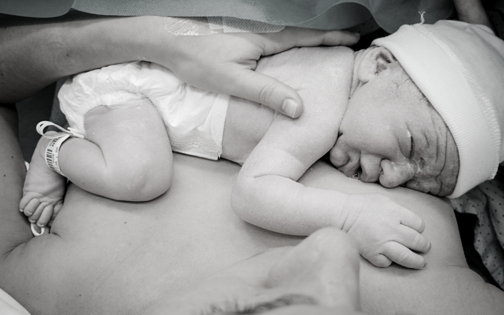 Newborn baby on mother's chest.