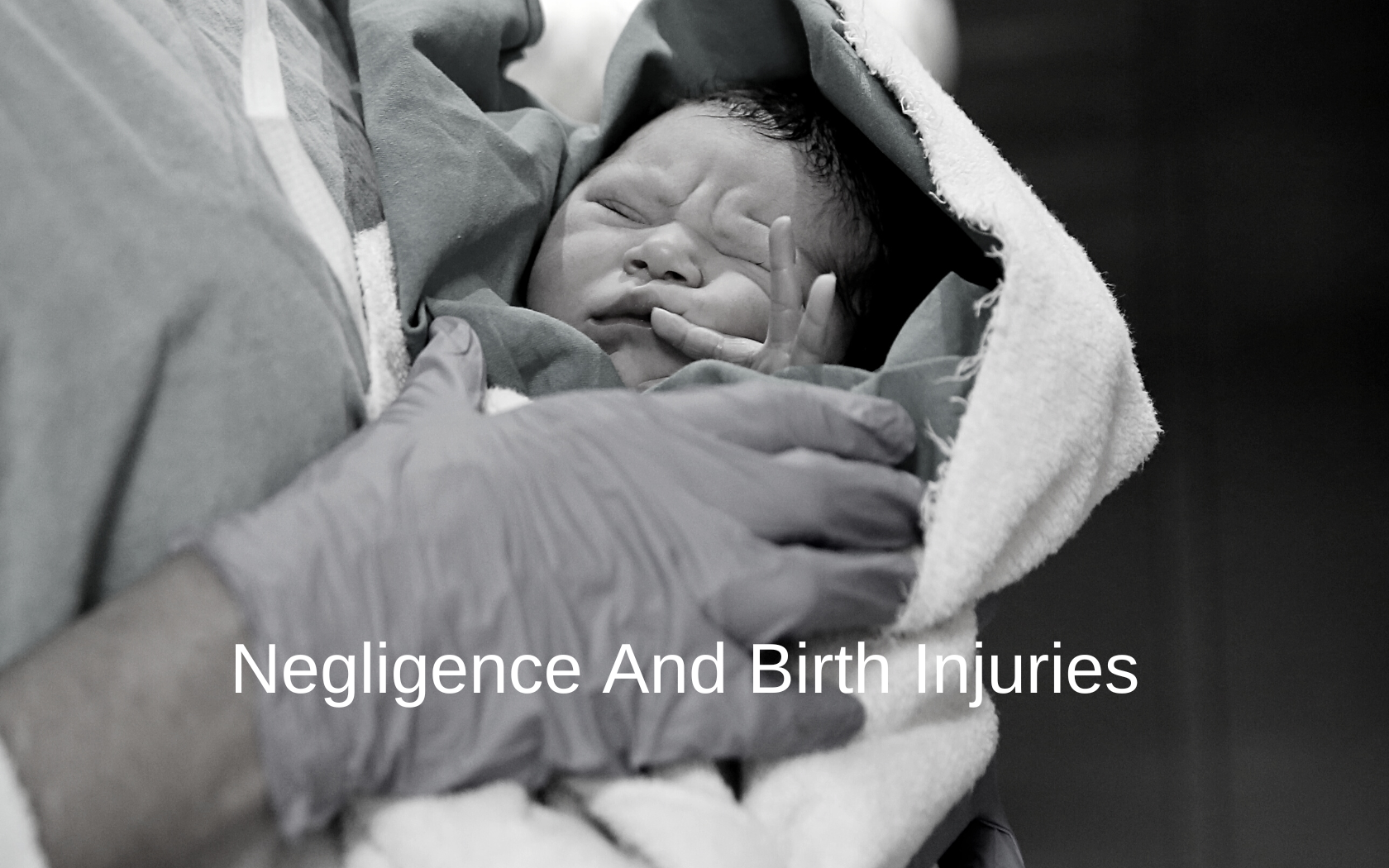Doctor holds baby with birth injury.