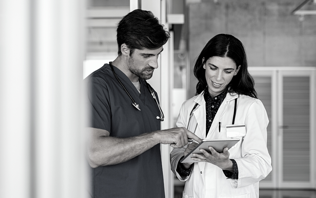 Nurse and doctor discuss patient's care.