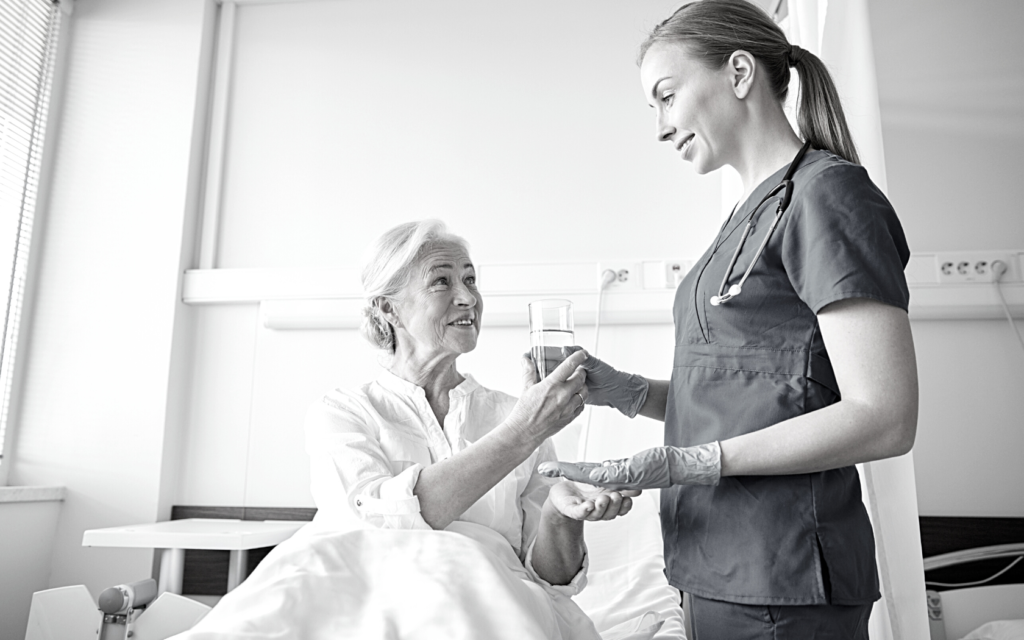 Nurse gives medicine to patient.