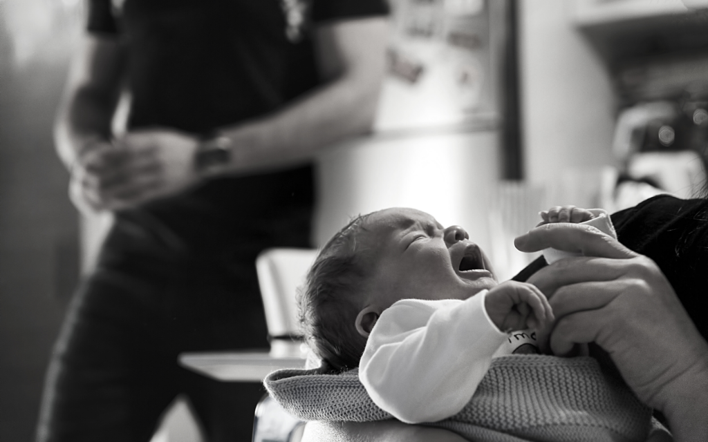 Newborn cries while in hospital.