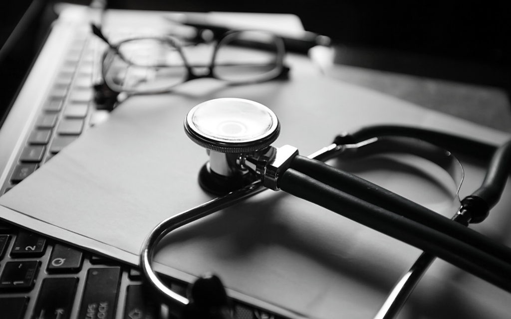 A doctor's stethoscope and glasses.