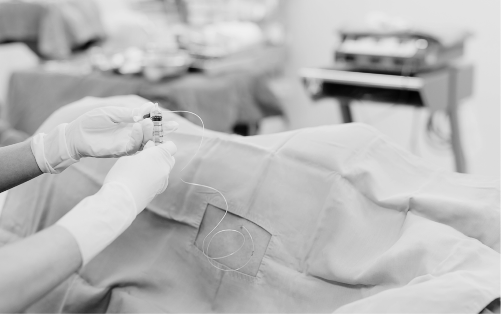 Anesthesiologist inserts epidural.
