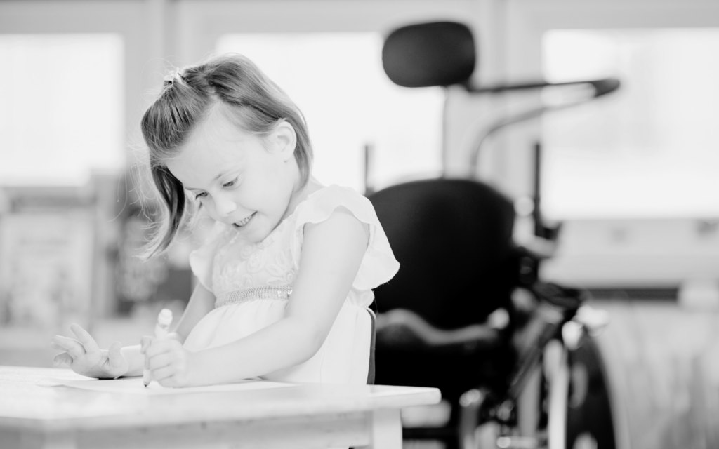 Little girl with cerebral palsy draws.