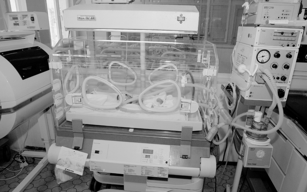 Newborn in NICU receiving cooling therapy for HIE.