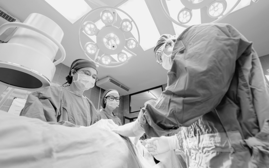 Surgical team in an operating room with patient.