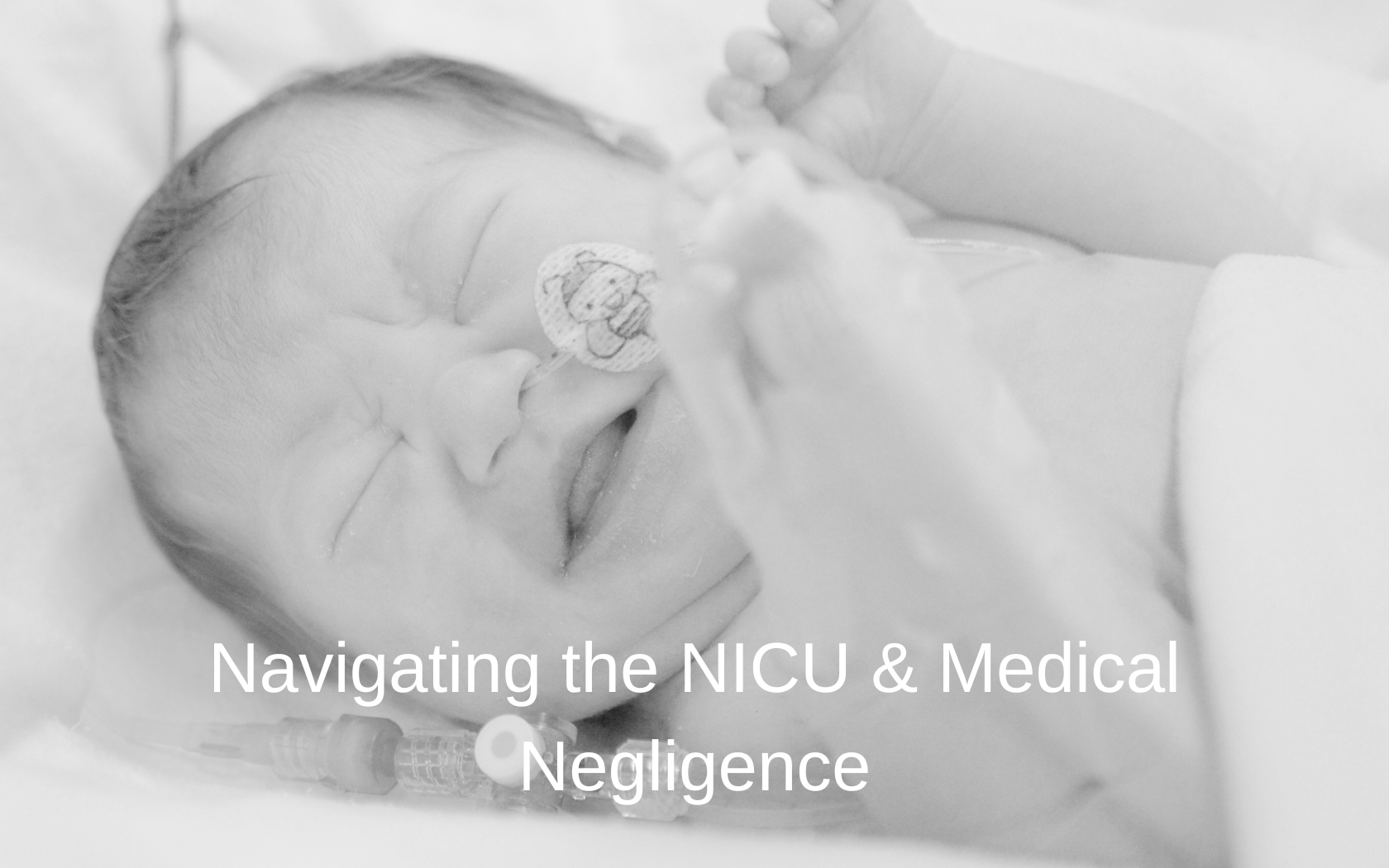 Baby crying in a NICU incubator.