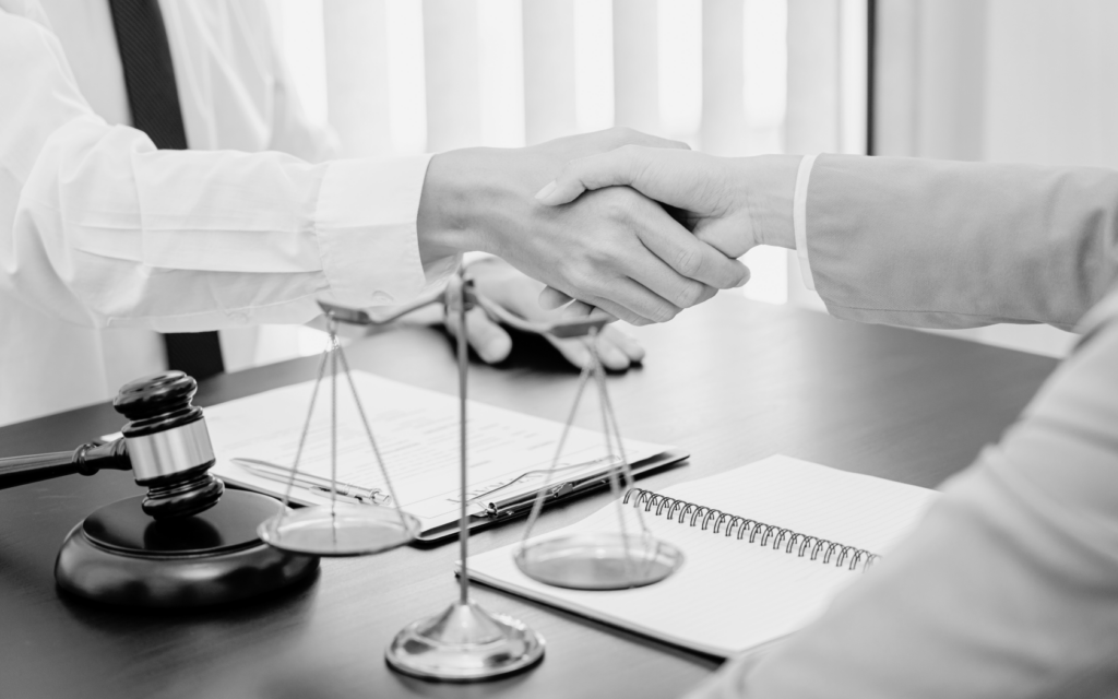 A lawyer and client shaking hands.