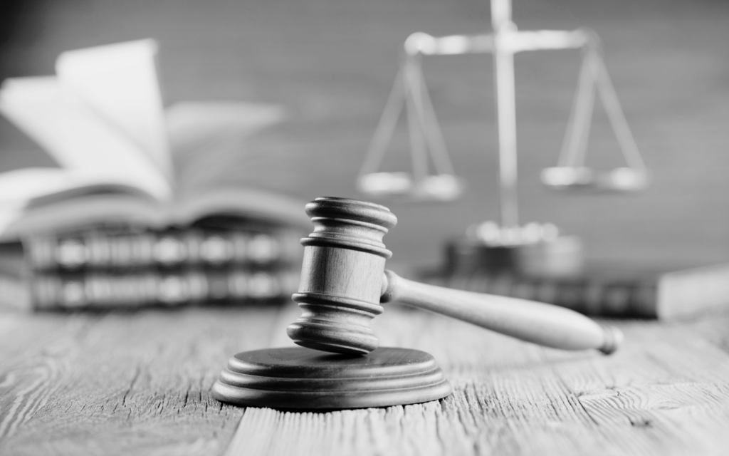 Close-up of a gavel on a desk, symbolizing legal action and justice in the courtroom.