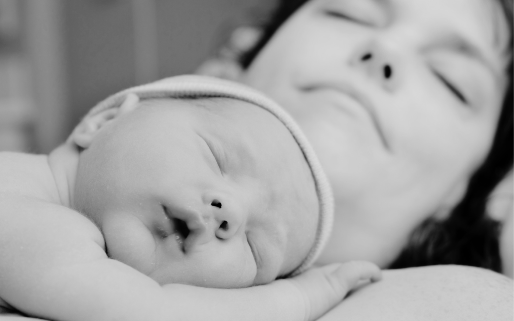 Newborn baby lying on mother's chest shortly after birth.