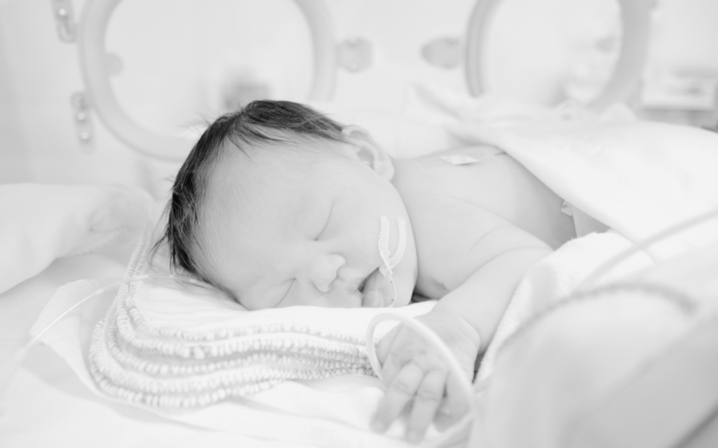 Newborn receiving oxygen support in NICU.