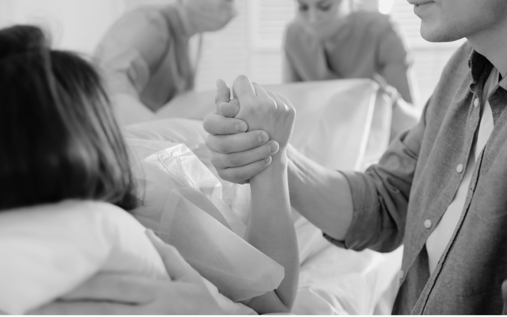 A woman experiencing contractions in a delivery room, surrounded by medical professionals.