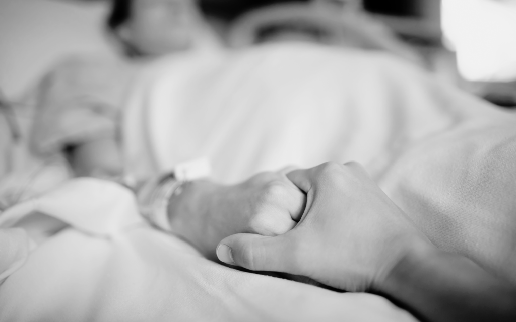 Loved one comforts patient in critical care due to HAI.