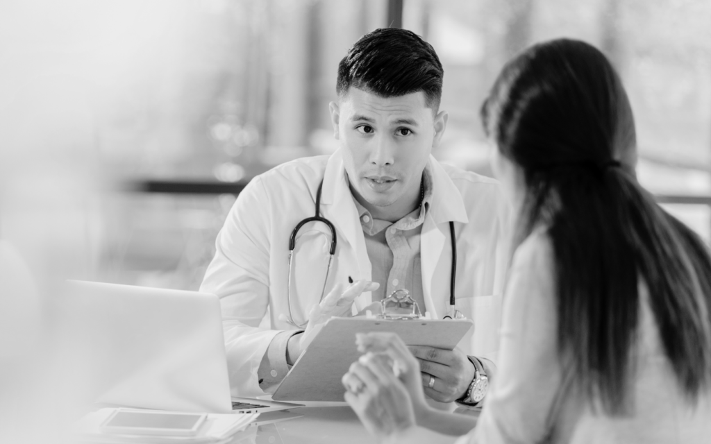 Parent discussing newborn's health with a doctor.
