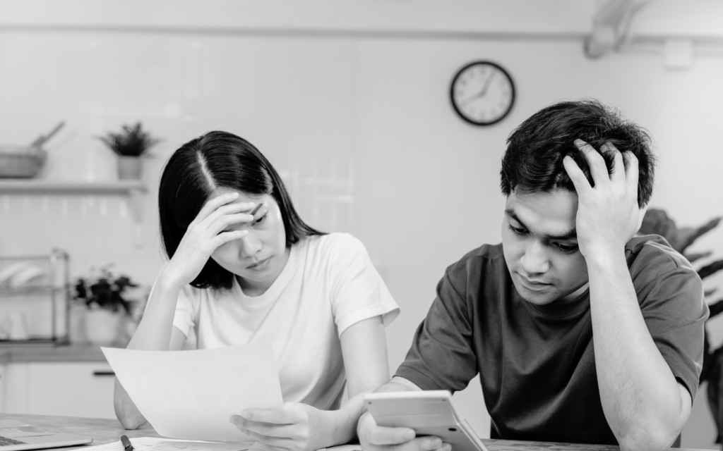 Two parents looking stressed and concerned as they go over their baby's NICU.