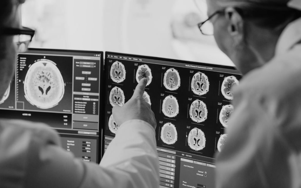 Radiologist looks at baby's MRI scan with doctor.