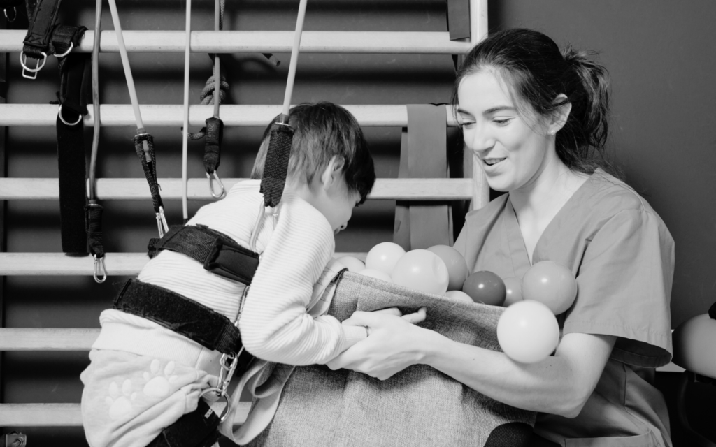 Therapist helping a child with PVL during physical therapy.