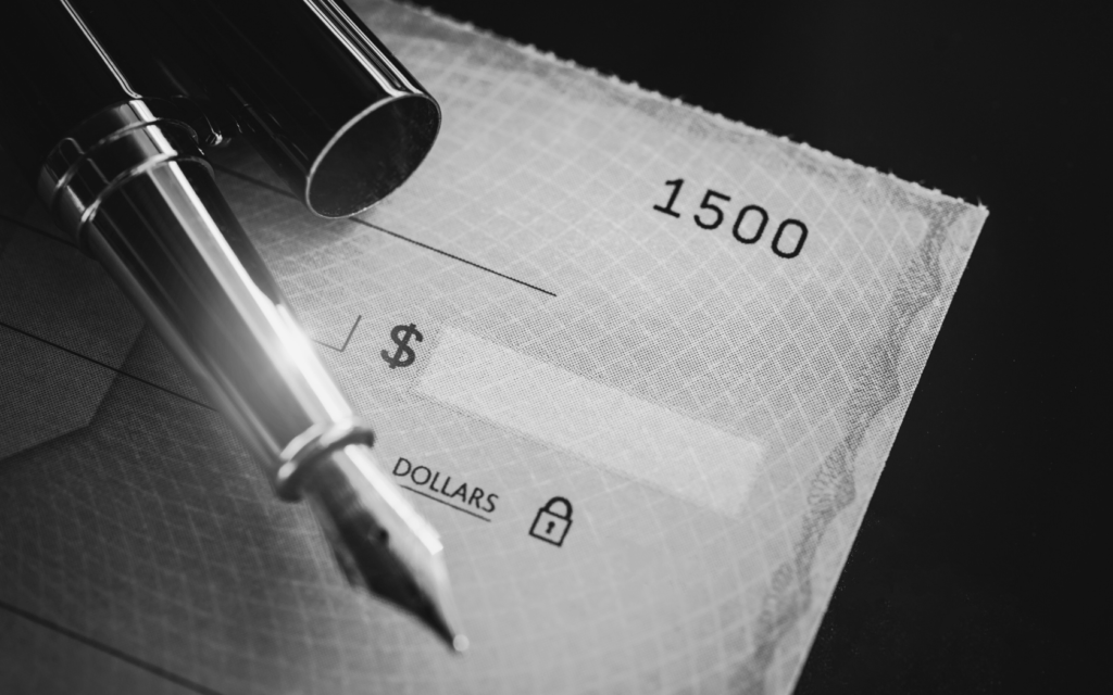 Blank check with a pen representing a birth injury settlement payment.