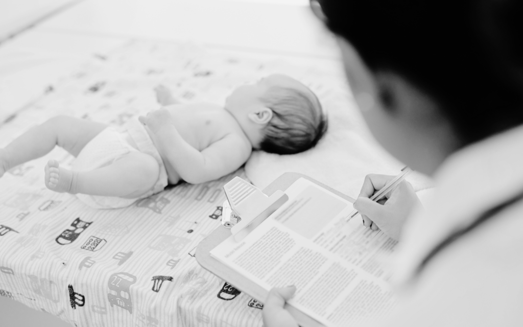 Doctor assessing a baby’s developmental milestones during a check-up.