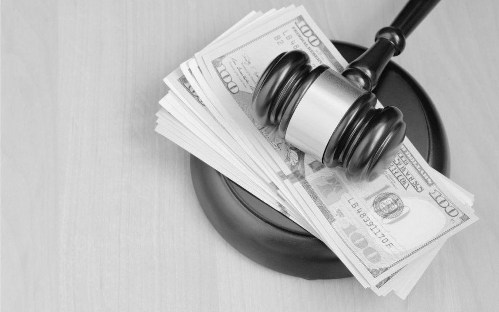 Gavel resting on a stack of money.