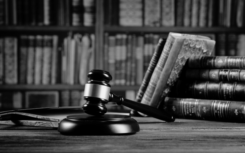 A gavel and legal books on a lawyer's desk.